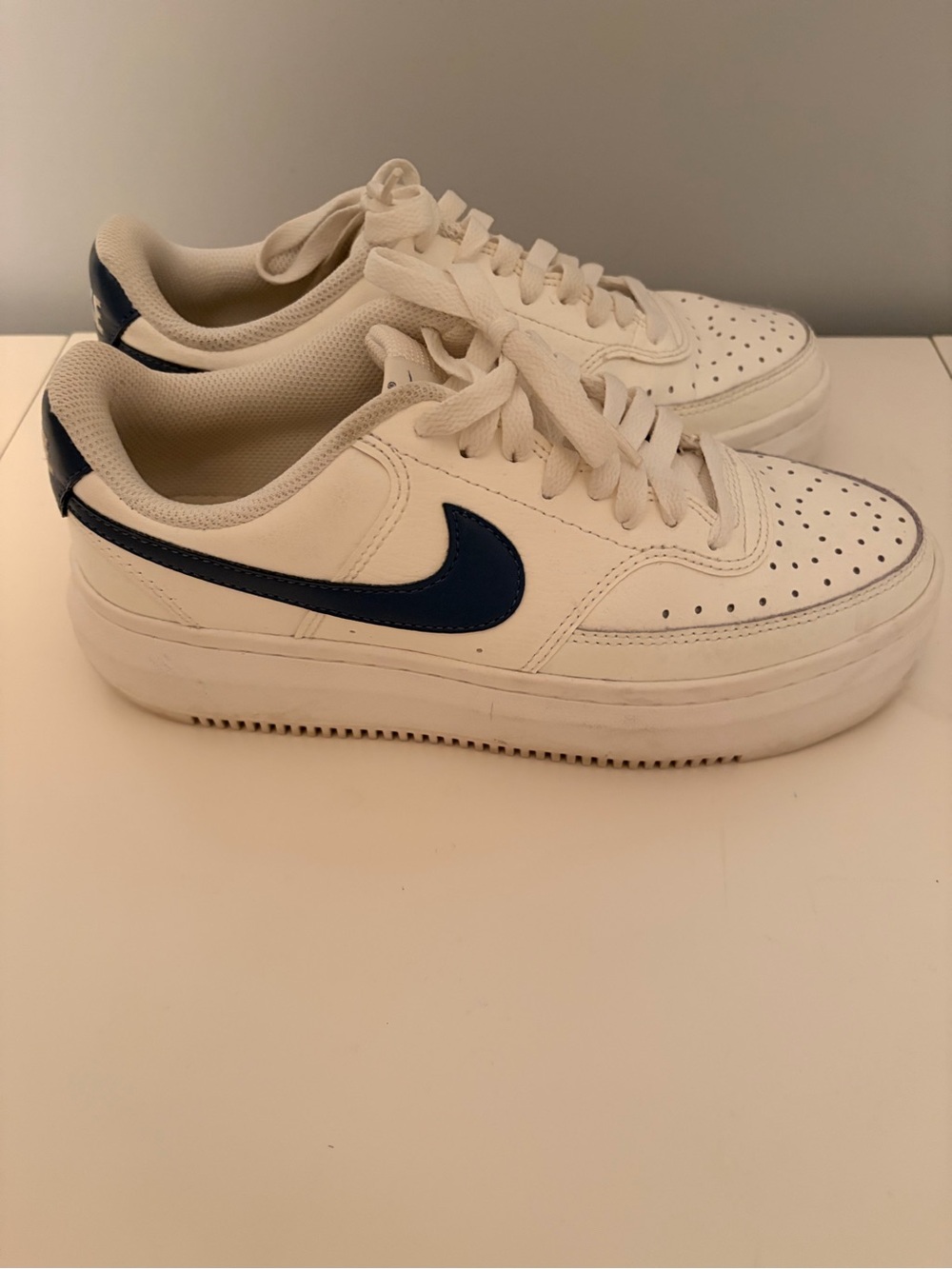 Nike Women's White Sneakers with Navy Swoosh Accent